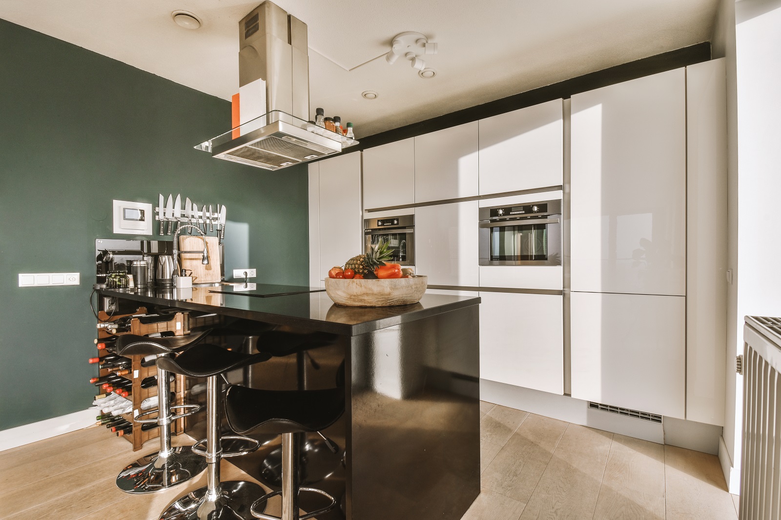An example of premium kitchen renovations with a green feature wall